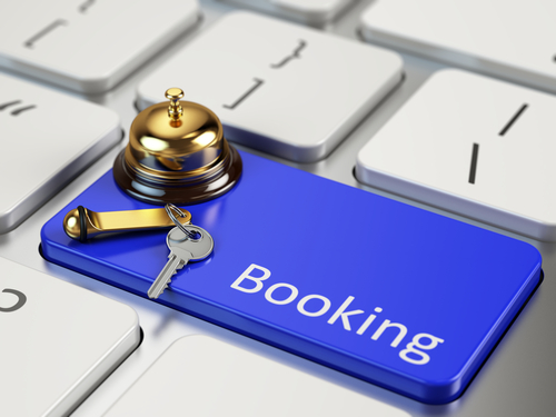 Blue keyboard key labeled Booking with a gold service bell and a room key