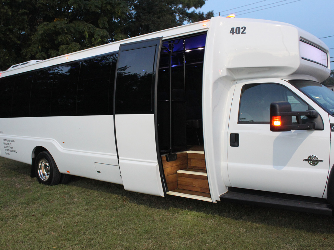 First Class Transportation minibus parked with its passenger door open and steps down