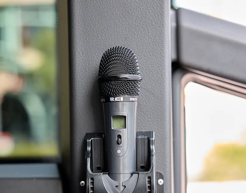 Wireless handheld microphone mounted inside a First Class Transportation motorcoach