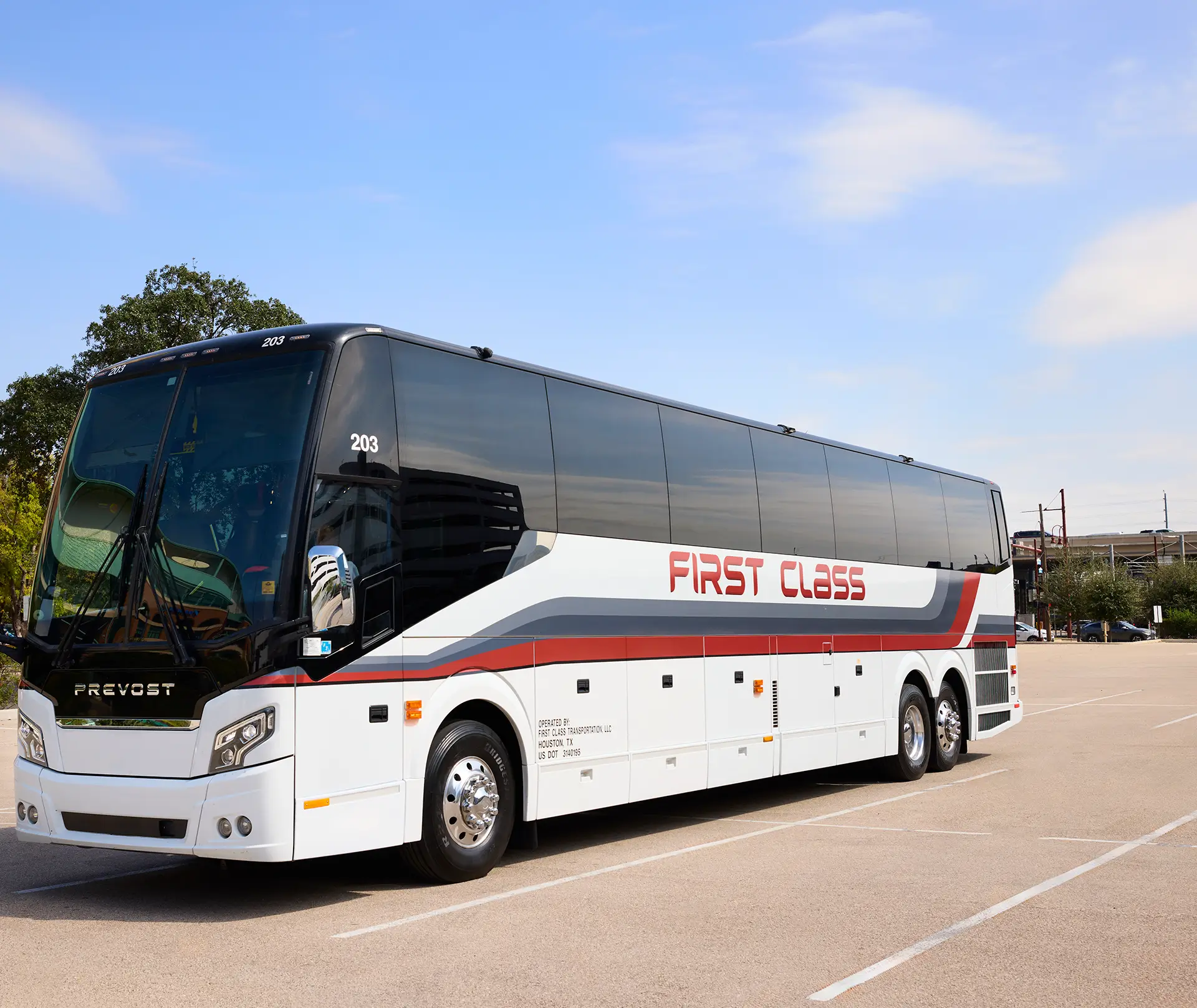 White First Class Transportation full-size Prevost motorcoach parked in a lot