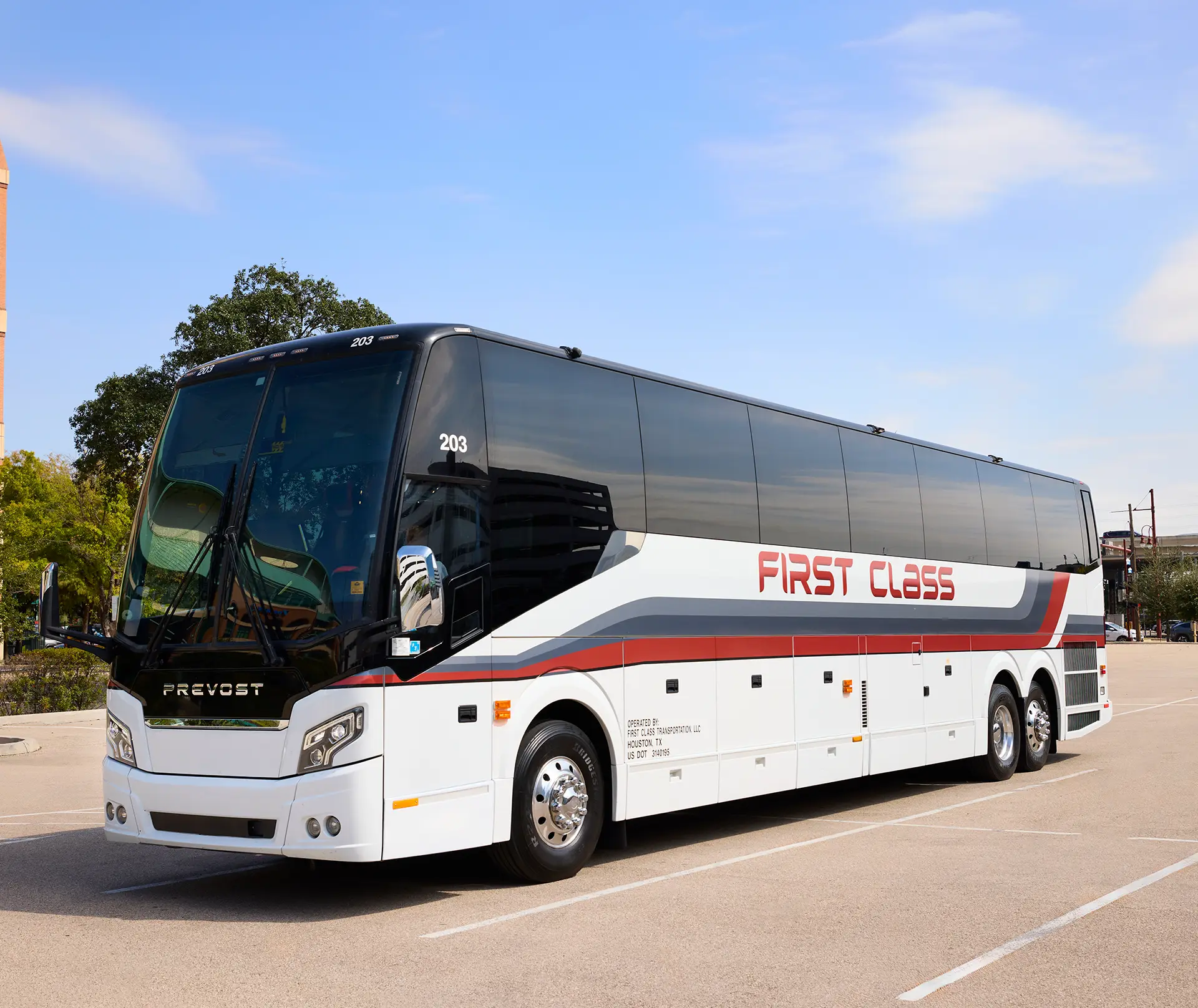 White First Class Transportation Prevost motorcoach parked in a paved lot