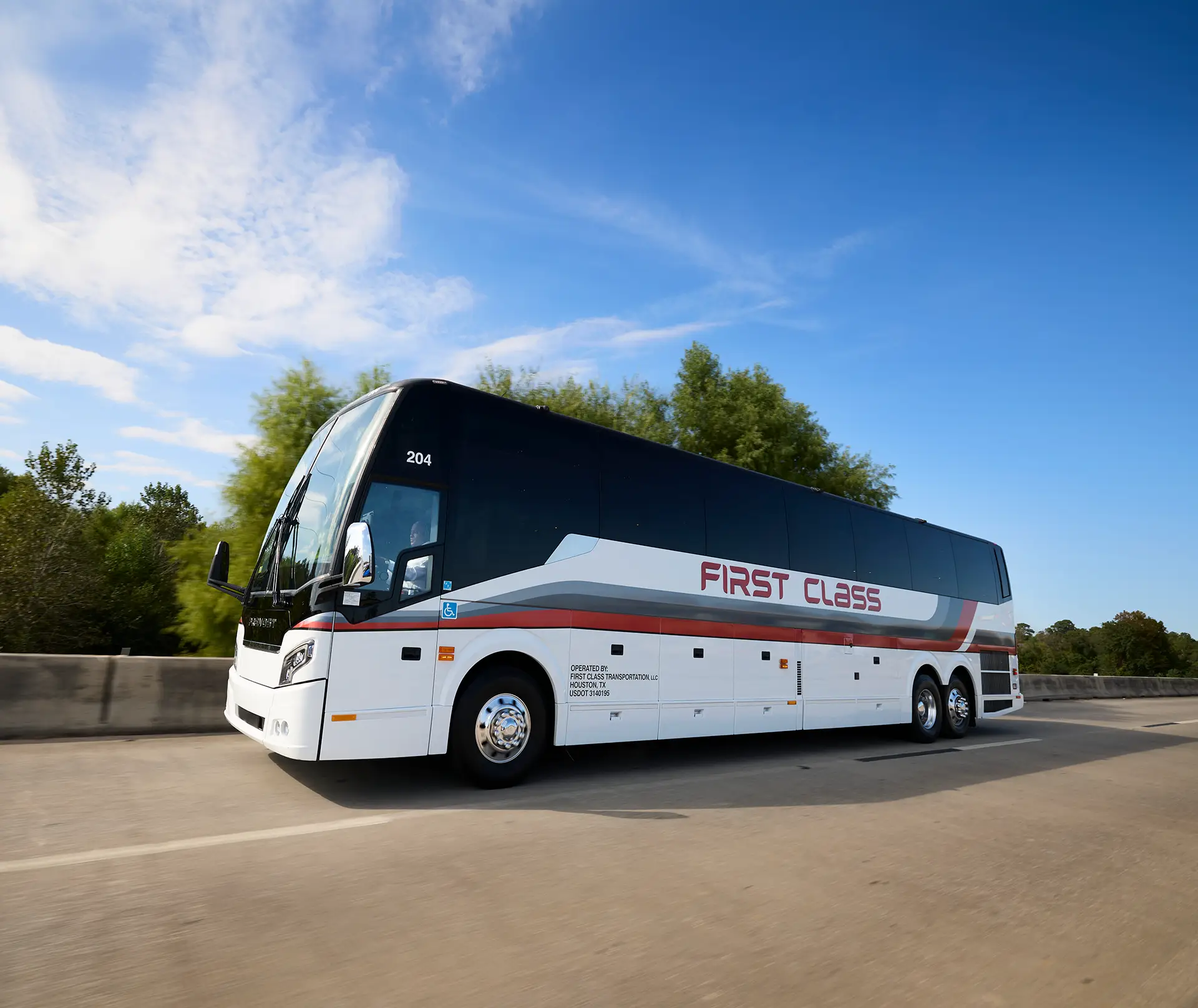 White First Class Transportation Prevost motorcoach traveling on a highway