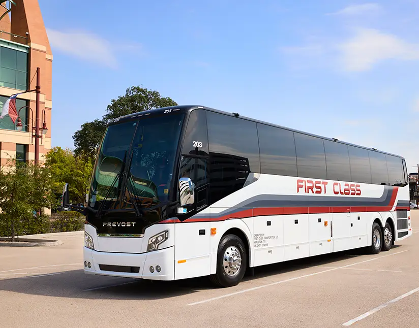 White First Class Transportation full-size motorcoach parked in a lot