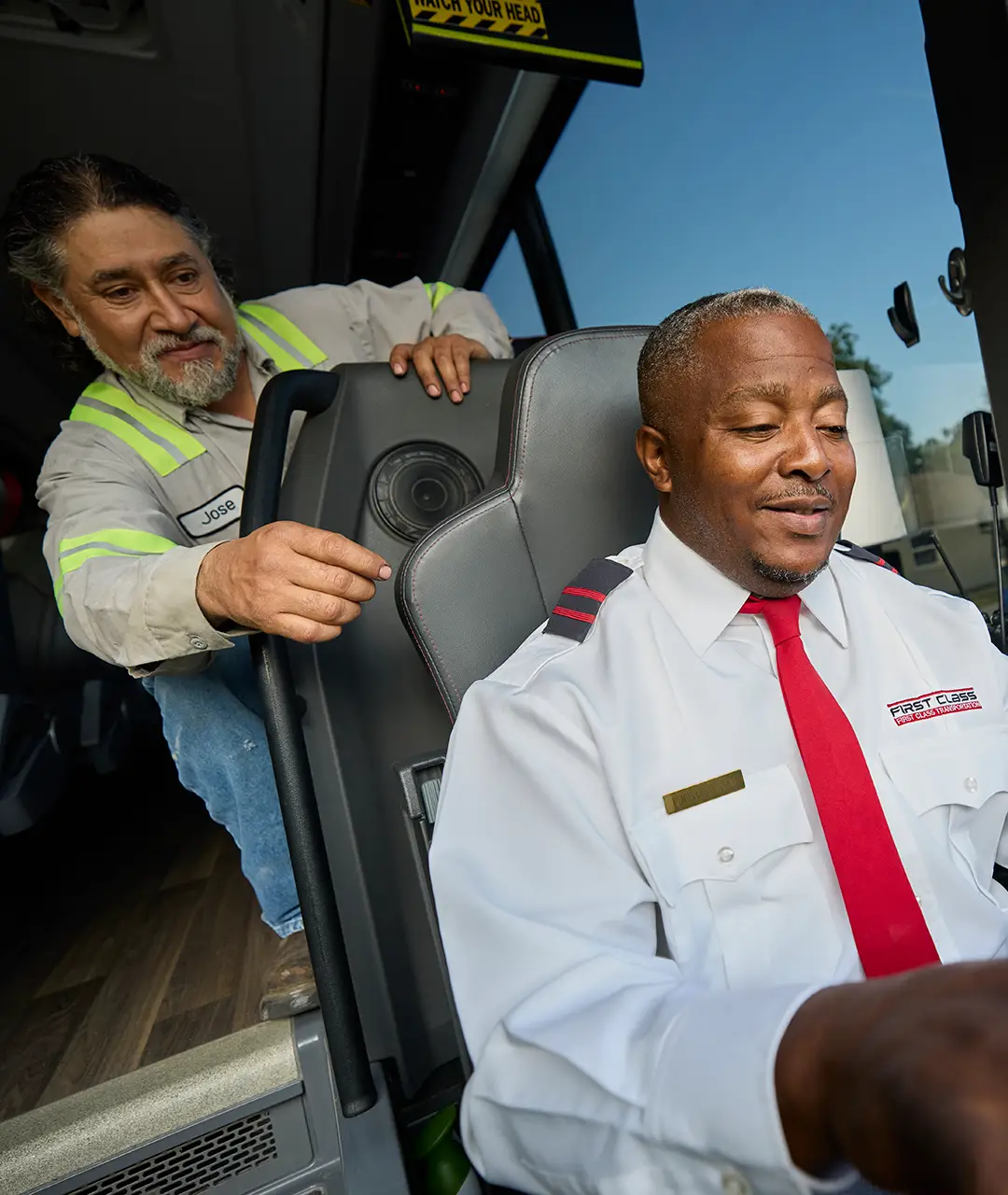 First Class Transportation mechanic showing a motorcoach passenger seat to a driver