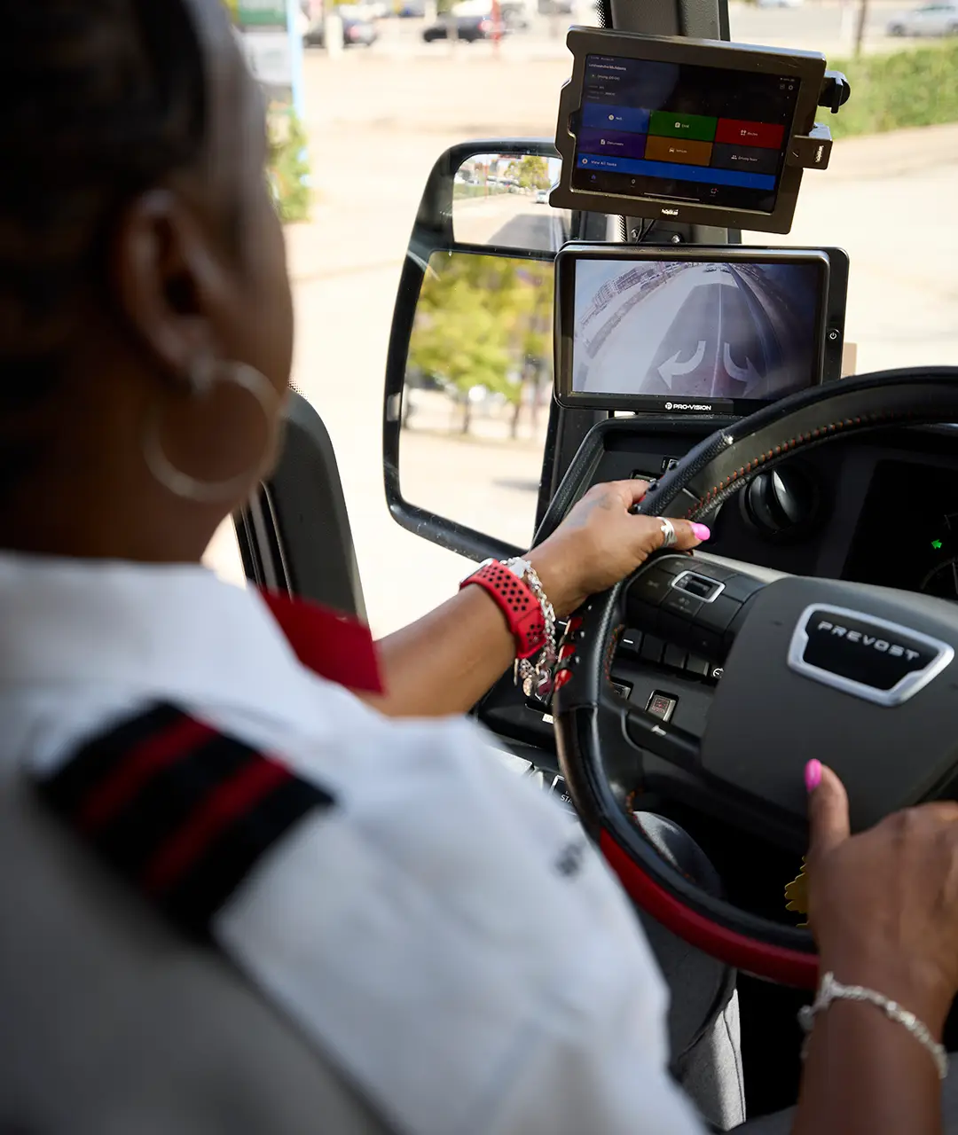 First Class Transportation driver using the onboard camera and safety display while driving a motorcoach