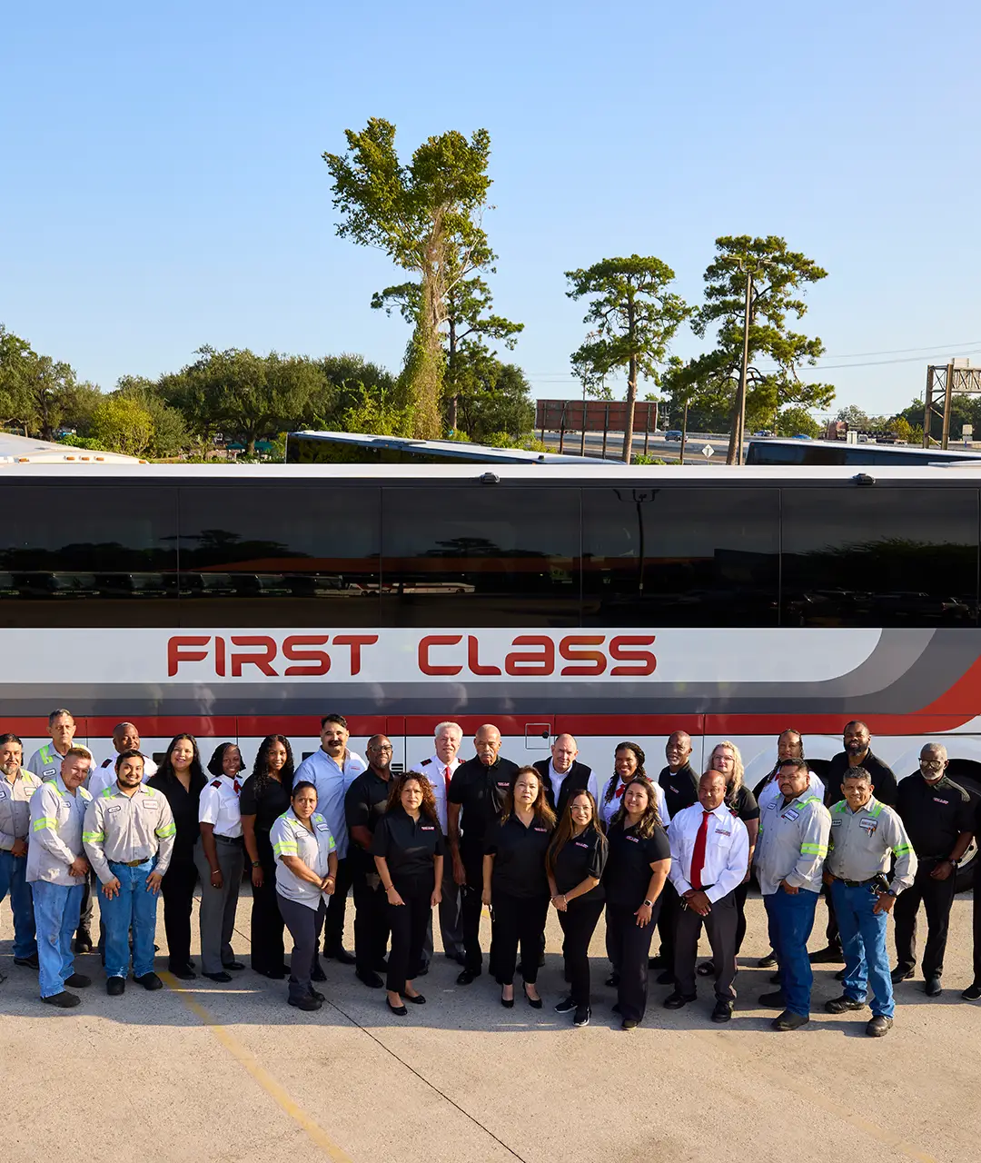 First Class Transportation team posed in front of a motorcoach