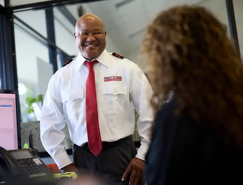 First Class Transportation staff member greeting a customer at the front desk